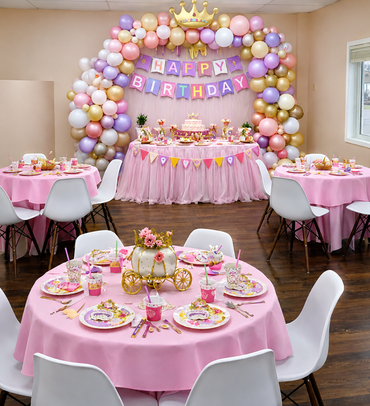 Princess-themed birthday party setup with balloon arch, banner, and decorated tables